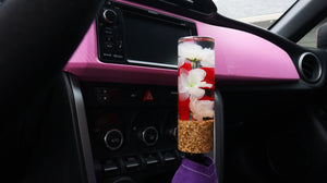 Cylinder shift knob with red and white flowers and a gold flake base