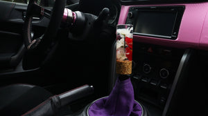 Cylinder shift knob with red and white flowers and a gold flake base